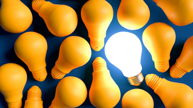 Light bulbs with one illuminated.