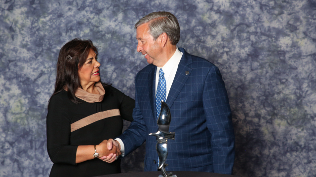 Award recipient shaking hands with presenter.