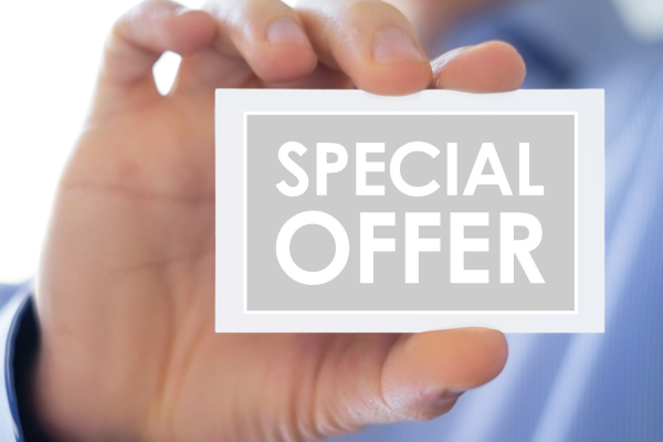 Mans hand holding a card that says special offer.