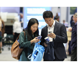 Two people at a conference looking at phone.