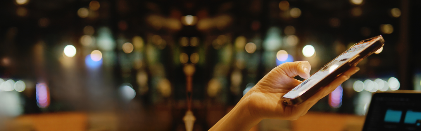 Hand holding and scrolling a cell phone.