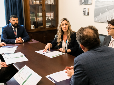 People in suits meeting at a table.